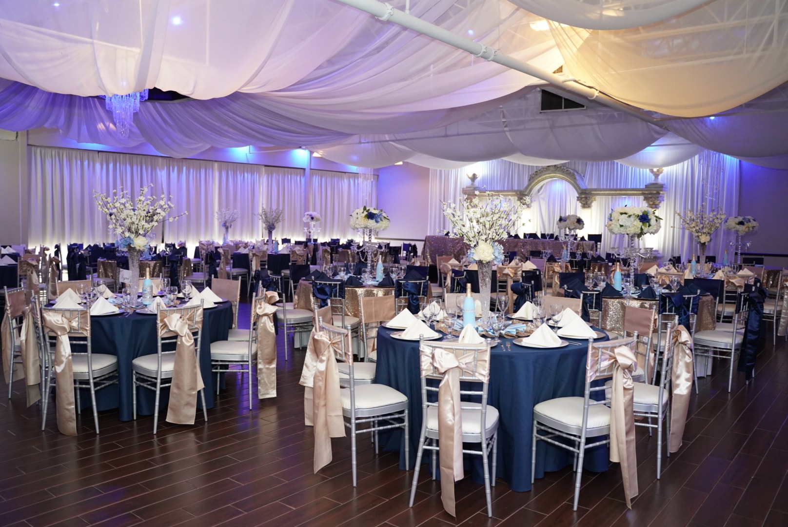 Elegant event setup with draped fabric and ambient lighting